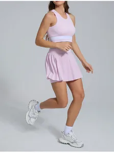 Detailed shot of a pink tennis skirt and crop top set shown in a dynamic running pose
