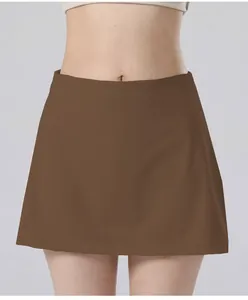 Detail shot of high-waisted brown tennis skirt featuring quick-dry yoga fabric design