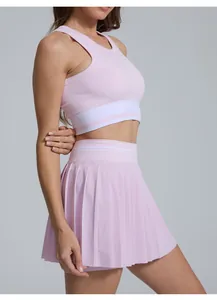 Side view detail of a pink pleated tennis skirt and matching racerback sports top set