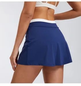 Rear view of high-waisted navy blue sports skort featuring white ribbed waistband