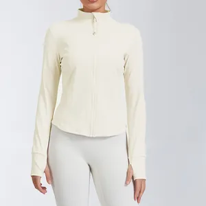 Macro detail of cream slim-fit yoga jacket with stand collar and thumbhole sleeves.