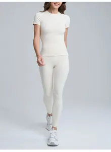 Professional model wearing a cream breathable yoga leggings and short sleeve top set