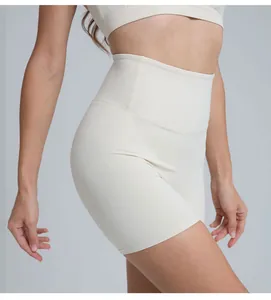 High-waisted cream yoga shorts featuring seamless design and peach-butt lifting effect