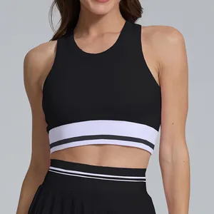 Close-up detail of breathable black sports crop top with striped white elastic band