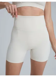 High-waist athletic yoga shorts in off-white showing compression fit and fabric texture.