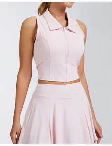 Detail of pink sleeveless zip-front polo collar sports top with matching pleated skirt