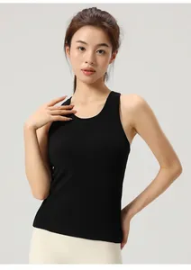 Close-up view of a woman wearing a slim fit black yoga tank top with a round neckline