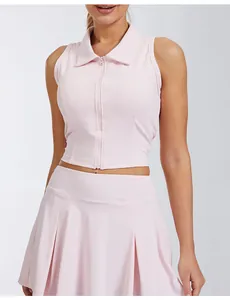 Close-up of pink sleeveless collared zip-up sports top and pleated tennis skirt set