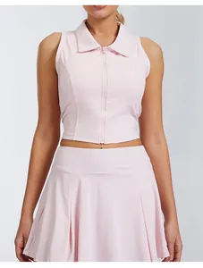 Detail shot of pink sleeveless tennis polo vest with front zipper and pleated skirt
