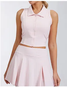 Close-up of a pink sleeveless sports polo top and matching pleated skirt for tennis.