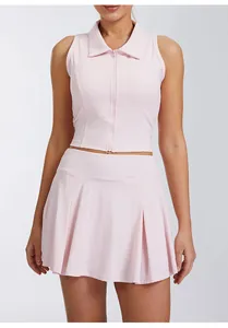 Close-up view of a pink sleeveless zip-up tennis top and matching pleated skirt set