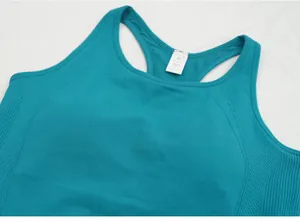Close-up detail of teal yoga tank top featuring ribbed side panels and racerback design