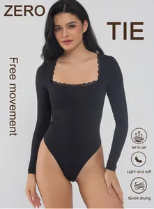 Detail view of a black square neck bodysuit with delicate lace trim and long sleeves