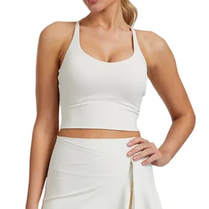 Soutien-gorge de sport blanc avec coussinets de poitrine et design dos croisé pour yoga.