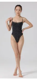 Elegant black floral bodysuit with lace trim and adjustable straps on Asian model