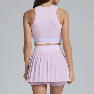 Back view of a pink high-waisted pleated tennis skirt and racerback sports top set.