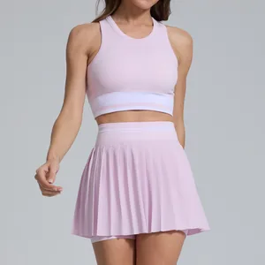 Two-piece pink tennis skirt set with breathable cropped tank top and high-waisted pleated skirt