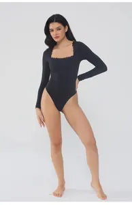 Close-up detail of black long sleeve bodysuit with square lace-trimmed neckline