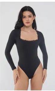 Detailed view of elegant black long-sleeved bodysuit featuring a lace-trimmed square neckline