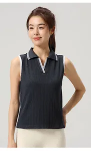 Close-up of navy sleeveless yoga tennis polo shirt with white trim and V-neckline