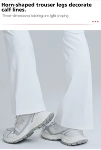 Detail view of white flare yoga pants with horn-shaped legs for fitness and running