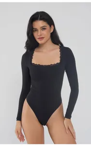 Detail view of black long sleeve bodysuit featuring elegant lace-trimmed square neckline.