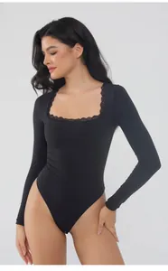 Detail view of the elegant square lace neckline on a long-sleeve black slim-fit bodysuit