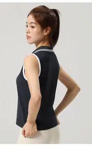 Detail view of navy blue seamless yoga tennis polo top with elegant white ribbed trim.