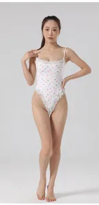 Frontal full-length view of a white heart pattern lace bodysuit worn by a female model
