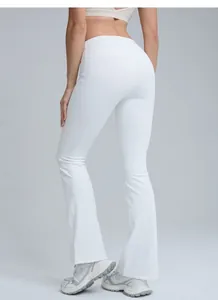 Rear view detail of high-waisted white flare yoga pants showing peach-lift design