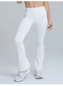 Close-up of white high-waisted micro-flare yoga pants showing sleek fit and style