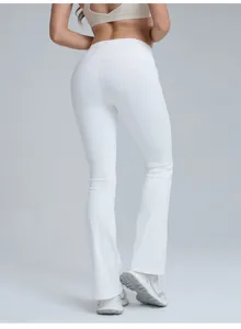 Back view detail of high-waisted white flared yoga pants showing peach butt lift design.