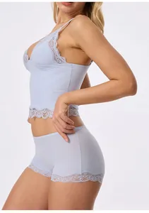 Side view of light blue lace camisole and matching boyshort underwear set on model