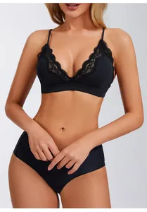 Detailed view of a sexy black lace-trimmed wireless triangle bra on a female model