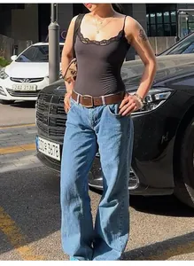 Stylish black lace-trimmed camisole top for women in a street-ready fashion look