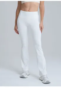 Front view of white high-waisted flare yoga pants on model showing peach butt lift