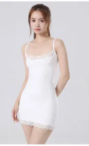 White bodycon dress with delicate lace trim on neckline and hem