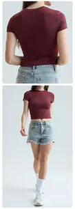 Full view showing back and front of a tight burgundy short-sleeved yoga T-shirt for women.