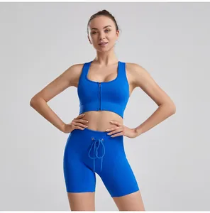 Professional blue ribbed drawstring yoga set featuring sports bra and shorts on model