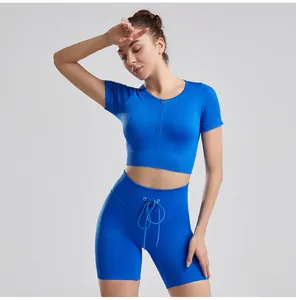 Athletic blue ribbed yoga set with drawstring shorts and zip-front short sleeve top