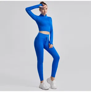 Detail of two-piece blue ribbed yoga set with long sleeve crop top and leggings