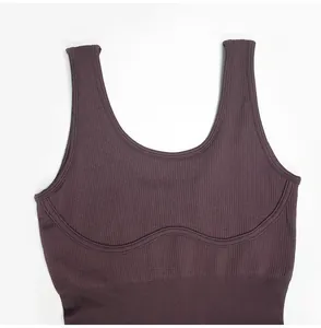 Detail macro view of dark ribbed U-neck yoga tank top featuring wide shoulder straps