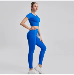 Detailed side view of woman in blue ribbed fitness set featuring short sleeve top and leggings