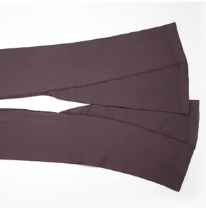Close-up detail showing the ribbed texture and flared leg stitching of a yoga jumpsuit
