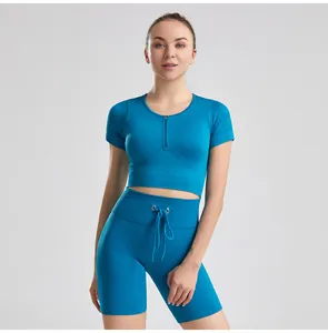 Close-up of women's blue ribbed yoga set featuring a front zipper top and drawstring shorts