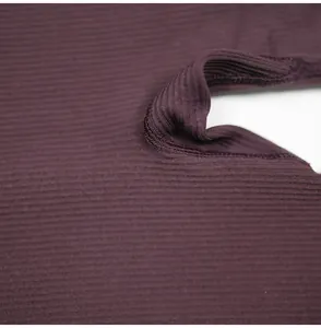 Close-up macro view of high-quality dark purple ribbed fabric and stitching detail.
