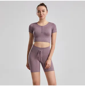Detailed view of ribbed purple yoga set featuring drawstring shorts and zip crop top