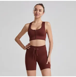 Close-up detail of women's ribbed fabric drawstring yoga set in rust brown color