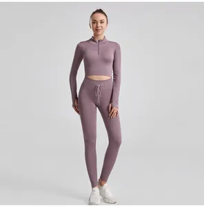 Detailed macro view of the mauve ribbed yoga set featuring drawstring waist and half-zip top