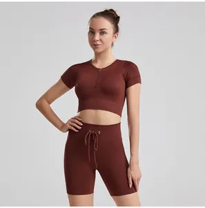 Two-piece ribbed yoga set with short sleeve zipper top and drawstring shorts in brown